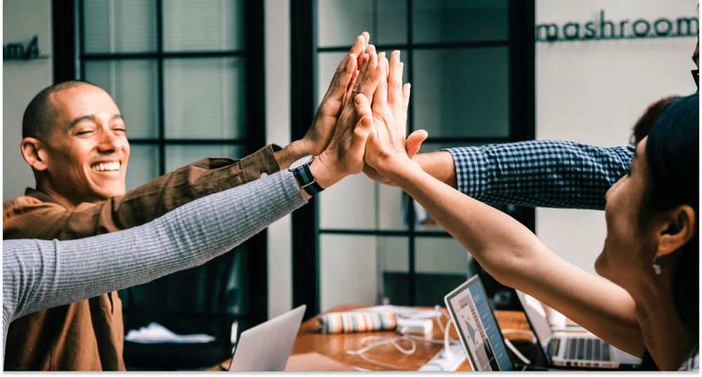 Colleagues at work highfive 1 Colleagues at work highfive 1